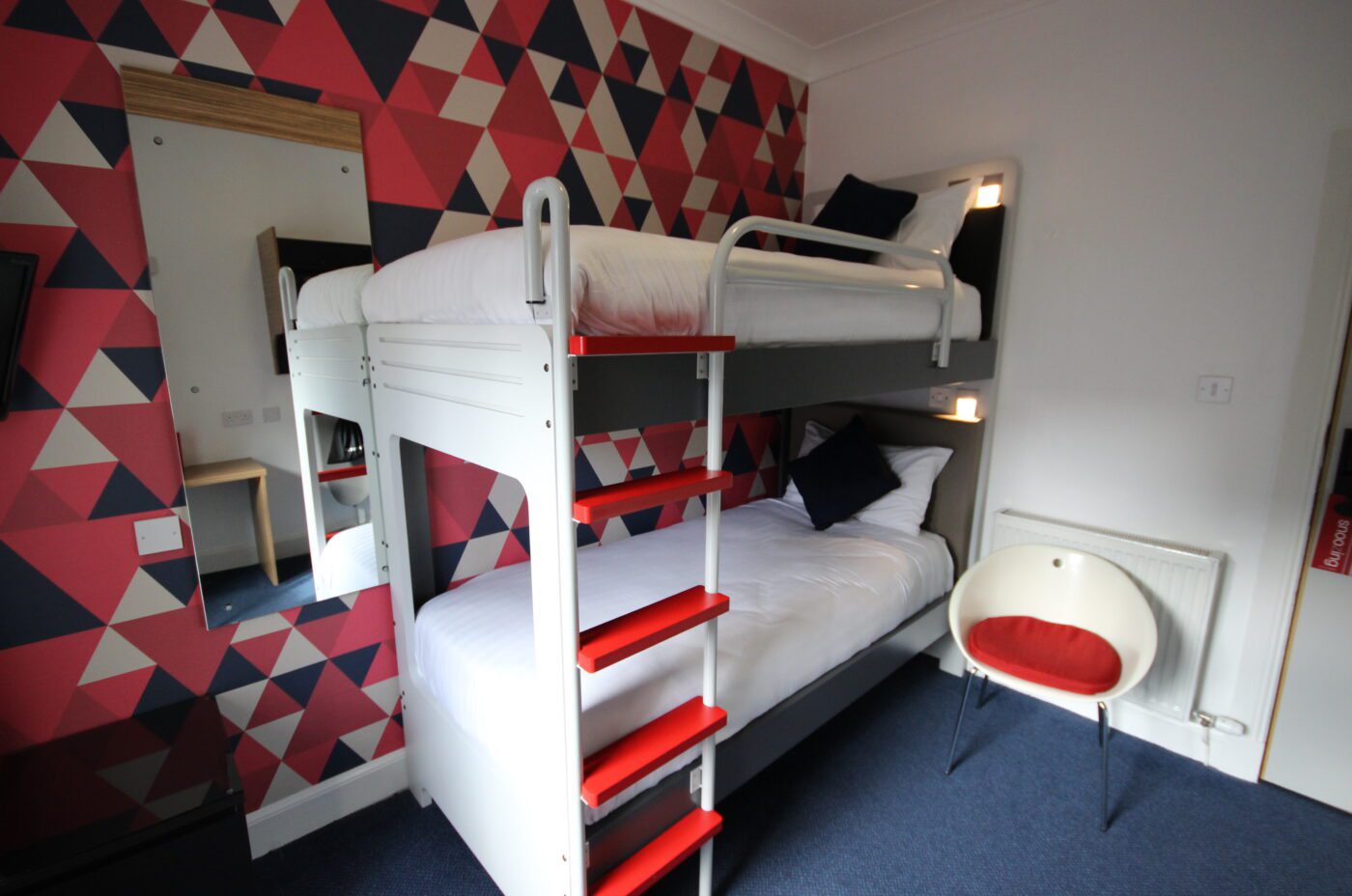 Cabin room with bunk beds and a mirror.