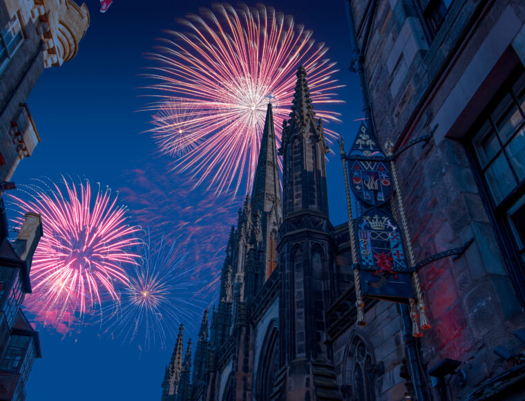 Celebratory fireworks for new year over The Hub from the Royal Mile, previously Church of Scotland Highland Tolbooth St John's Church in Edinburgh during last night of year. Christmas atmosphere.
