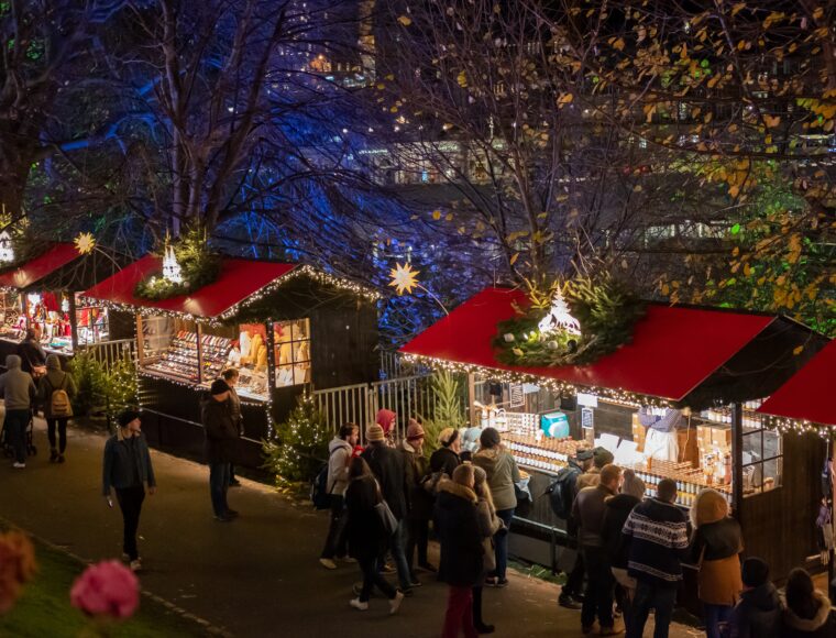 a view of Edinburgh Christmas Markets taken from an elevated view. The Edinburgh Christmas market includes a number of market stalls on Princes Street.